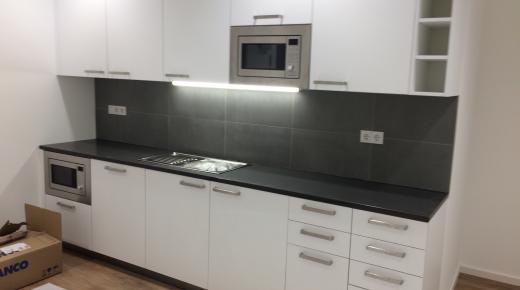 Weiße Küchenzeile mit dunkler Rückwand